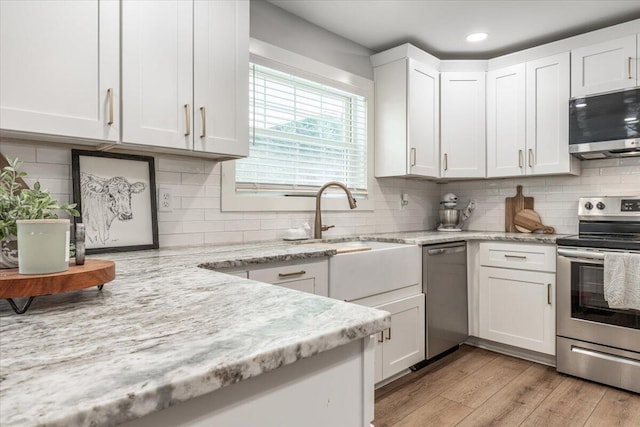 918 Old Lafayette Rd, Chickamauga, GA 30707 - kitchen featuring appliances with stainless steel finishes, white cabinetry, light wood-style floors, tasteful backsplash, and recessed lighting