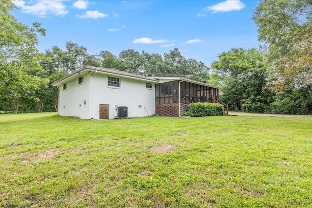 918 Old Lafayette Rd, Chickamauga, GA 30707 - back of property featuring a sunroom, a yard, brick siding, and view of wooded area