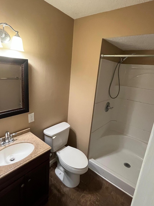4510 Bluffwood Way, Cohutta, GA 30710 - bathroom featuring toilet, a shower, vanity, and a textured ceiling