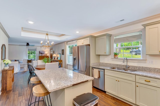 168 Middle Rd, Lookout Mountain, GA 30750 - kitchen with stainless steel appliances, a kitchen bar, open floor plan, light stone counters, and dark wood-type flooring
