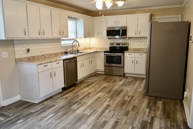 503 Kirby Dr, Cleveland, TN 37323 - kitchen with appliances with stainless steel finishes, crown molding, a ceiling fan, white cabinets, and backsplash
