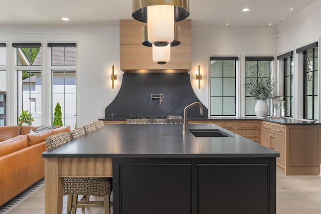3634 Falkirk Way, Ooltewah, TN 37363 - kitchen featuring dark countertops, modern cabinets, light wood finished floors, tasteful backsplash, and a large island