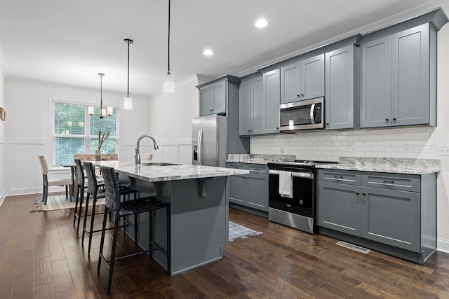 6434 Satjanon Dr, Ooltewah, TN 37363 - kitchen with stainless steel appliances, gray cabinets, crown molding, light stone counters, and decorative backsplash