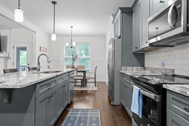 6434 Satjanon Dr, Ooltewah, TN 37363 - kitchen with appliances with stainless steel finishes, gray cabinetry, dark wood-type flooring, and ornamental molding