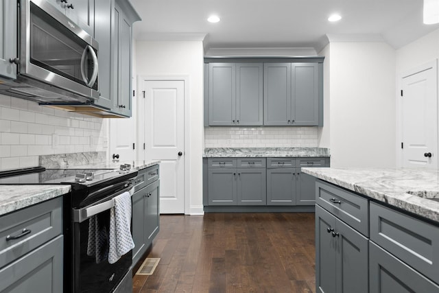 6434 Satjanon Dr, Ooltewah, TN 37363 - kitchen featuring electric stove, stainless steel microwave, gray cabinetry, tasteful backsplash, and dark wood-type flooring