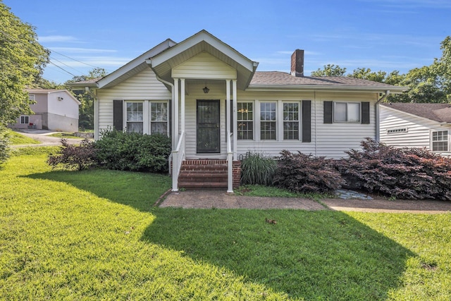 3612 Tacoma Ave, Chattanooga, TN 37415 - view of front of home with a chimney, a front lawn, and a shingled roof