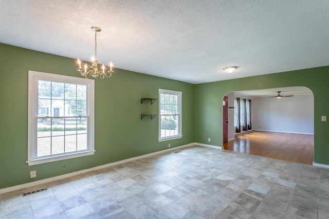 105 Joyce Ave, Red Bank, TN 37415 - empty room with arched walkways, a chandelier, a ceiling fan, and a textured ceiling