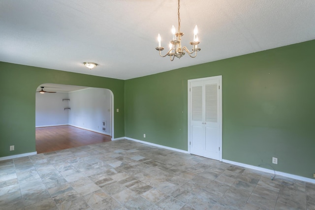 105 Joyce Ave, Red Bank, TN 37415 - empty room with a chandelier, ceiling fan, arched walkways, and a textured ceiling