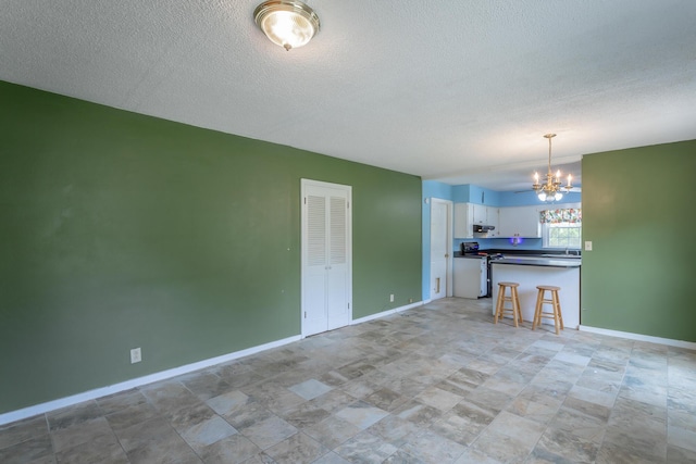 105 Joyce Ave, Red Bank, TN 37415 - kitchen with a chandelier, electric stove, dark countertops, a textured ceiling, and white cabinets