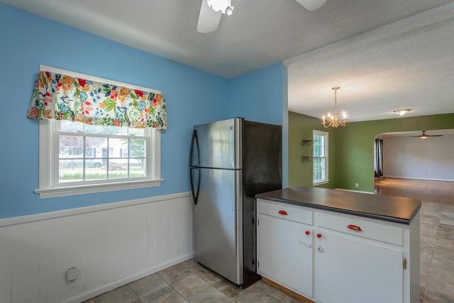 105 Joyce Ave, Red Bank, TN 37415 - kitchen featuring freestanding refrigerator, ceiling fan, dark countertops, a peninsula, and a wainscoted wall