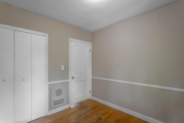 105 Joyce Ave, Red Bank, TN 37415 - unfurnished bedroom featuring wood finished floors, a closet, and heating unit