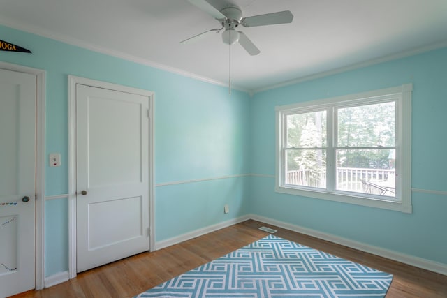 105 Joyce Ave, Red Bank, TN 37415 - unfurnished bedroom featuring wood finished floors, ornamental molding, and a ceiling fan