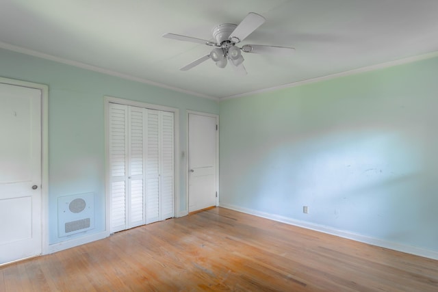 105 Joyce Ave, Red Bank, TN 37415 - unfurnished bedroom featuring heating unit, ornamental molding, light wood-style floors, ceiling fan, and a closet