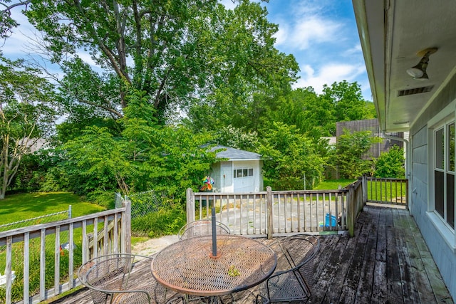 105 Joyce Ave, Red Bank, TN 37415 - wooden deck with outdoor dining space, a yard, a shed, and view of wooded area