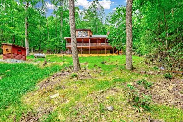 879 Amy Creek Cir, Ellijay, GA 30540 - rear view of property featuring a deck, an outbuilding, and a wooded view