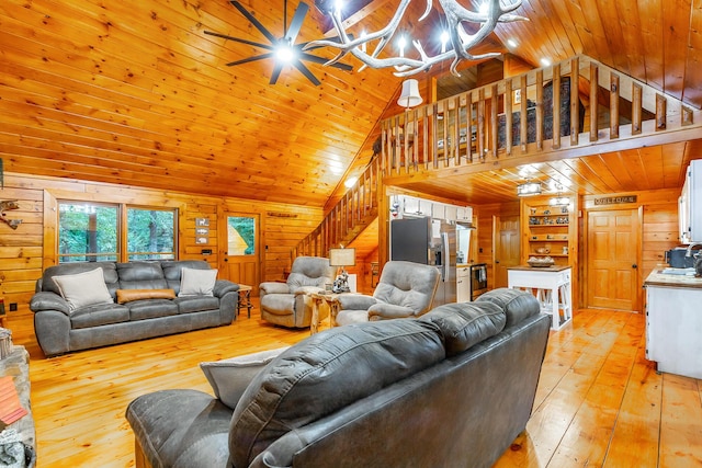 879 Amy Creek Cir, Ellijay, GA 30540 - living room with wooden walls, stairs, light wood-style floors, a chandelier, and wood ceiling