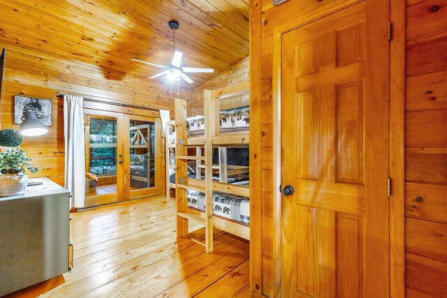 879 Amy Creek Cir, Ellijay, GA 30540 - bedroom with french doors, wood walls, and light wood-style floors
