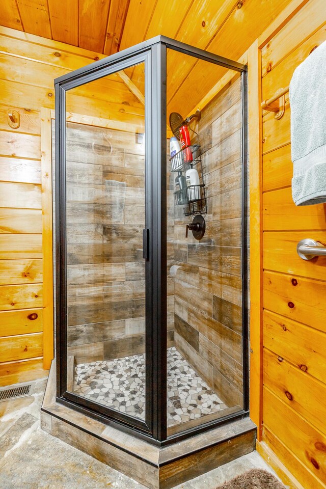 879 Amy Creek Cir, Ellijay, GA 30540 - bathroom featuring a stall shower, wooden ceiling, and wooden walls