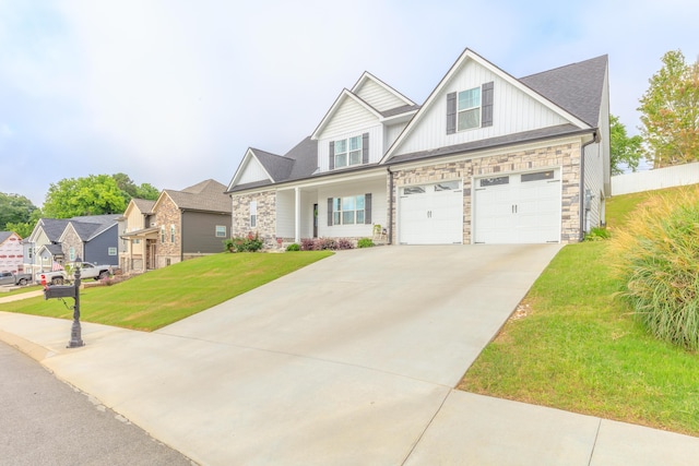905 Live Oak Rd, Ringgold, GA 30736 - craftsman house featuring stone siding, an attached garage, a front yard, and board and batten siding