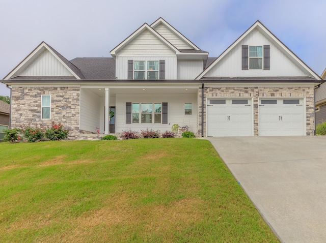 905 Live Oak Rd, Ringgold, GA 30736 - view of front of property with concrete driveway, board and batten siding, stone siding, a front yard, and a garage