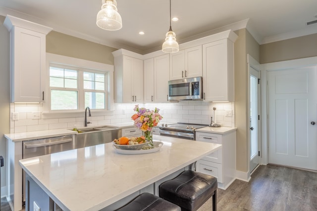 905 Live Oak Rd, Ringgold, GA 30736 - kitchen featuring stainless steel appliances, ornamental molding, white cabinets, dark wood finished floors, and recessed lighting