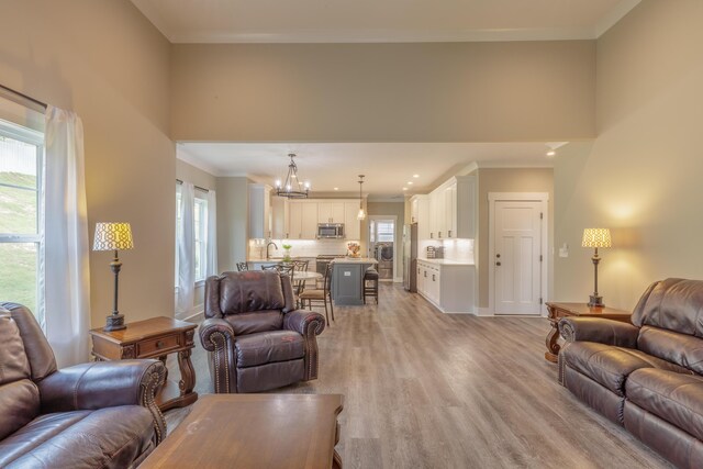 905 Live Oak Rd, Ringgold, GA 30736 - living room featuring healthy amount of natural light, light wood-type flooring, a chandelier, crown molding, and recessed lighting