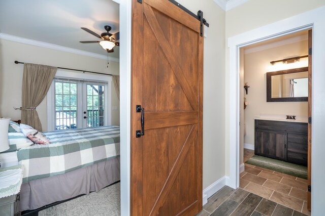 343 Highlands Forest Rd, Menlo, GA 30731 - bedroom with a barn door, crown molding, connected bathroom, dark wood-type flooring, and access to outside