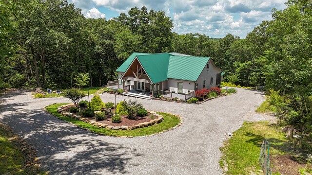 343 Highlands Forest Rd, Menlo, GA 30731 - view of front of home with curved driveway, a forest view, a metal roof, and a porch