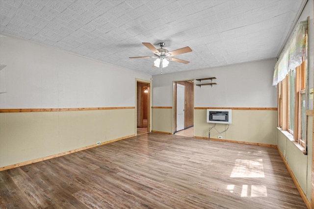 1815 City View St, Dalton, GA 30720 - empty room with heating unit, wood finished floors, ceiling fan, and plenty of natural light