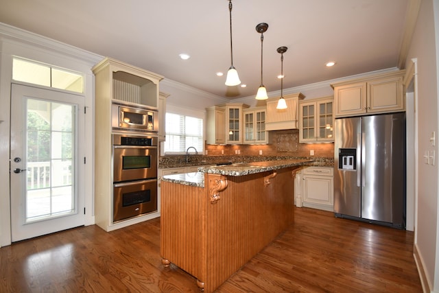 9532 Wandering Way, Ooltewah, TN 37363 - kitchen featuring stainless steel appliances, a kitchen island, a kitchen bar, dark wood-style flooring, and decorative backsplash