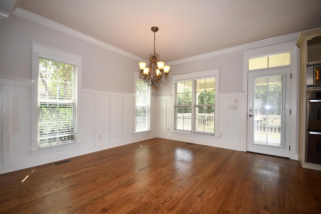 9532 Wandering Way, Ooltewah, TN 37363 - unfurnished dining area with a decorative wall, a chandelier, dark wood-style floors, a wainscoted wall, and plenty of natural light