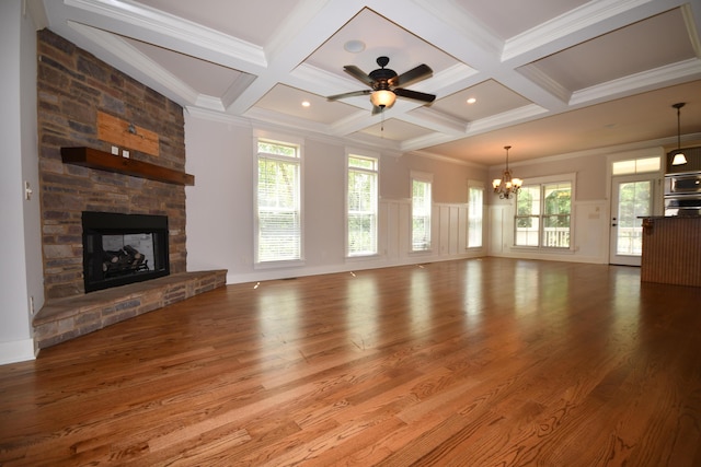 9532 Wandering Way, Ooltewah, TN 37363 - unfurnished living room featuring coffered ceiling, wood finished floors, a chandelier, beam ceiling, and a stone fireplace