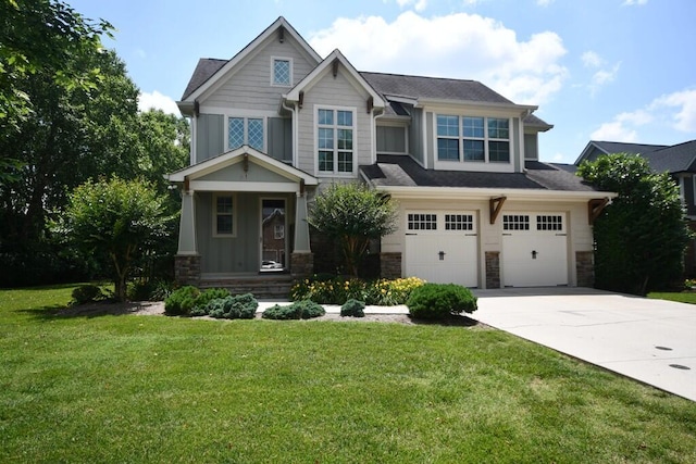 9532 Wandering Way, Ooltewah, TN 37363 - craftsman house with stone siding, concrete driveway, a garage, board and batten siding, and a front lawn