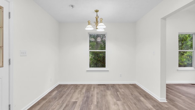 607 Gregory Ln, Lafayette, GA 30728 - unfurnished room with wood finished floors, a chandelier, and a pendent fire sprinkler