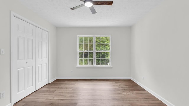 607 Gregory Ln, Lafayette, GA 30728 - unfurnished bedroom with wood finished floors, a closet, a textured ceiling, and a ceiling fan