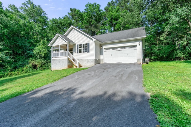 63 Apple Ln, Ringgold, GA 30736 - ranch-style house with asphalt driveway, covered porch, a garage, and a front yard