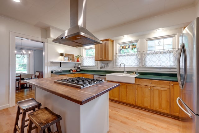 511 Georgia Ave, Signal Mountain, TN 37377 - kitchen with island range hood, stainless steel appliances, wood counters, crown molding, and light wood-style flooring