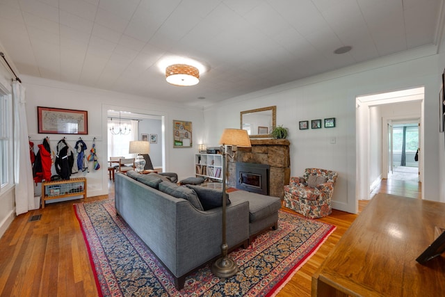 511 Georgia Ave, Signal Mountain, TN 37377 - living area featuring hardwood / wood-style flooring, a stone fireplace, a chandelier, and crown molding