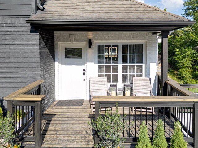 332 Oliver St, Chattanooga, TN 37405 - doorway to property with brick siding, outdoor dining space, and a shingled roof