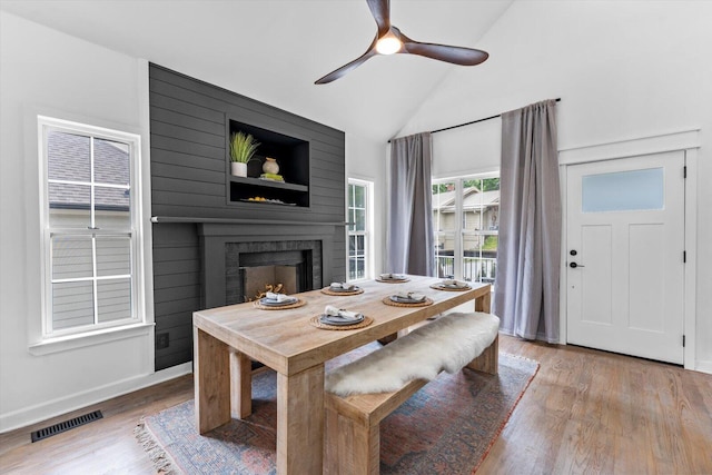 332 Oliver St, Chattanooga, TN 37405 - dining area featuring wood finished floors, a fireplace, a ceiling fan, and high vaulted ceiling