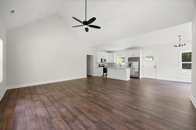 10822 Dallas Hollow Rd, Soddy Daisy, TN 37379 - unfurnished living room with ceiling fan, dark wood-type flooring, a chandelier, and high vaulted ceiling
