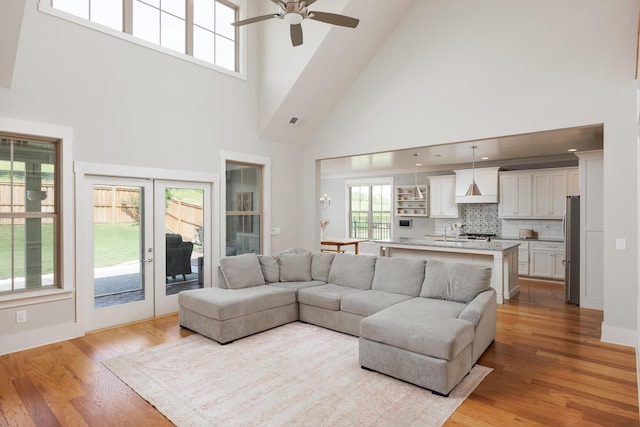 10607 Flicker Way, Apison, TN 37302 - living room featuring a high ceiling, ceiling fan, and light wood-style flooring