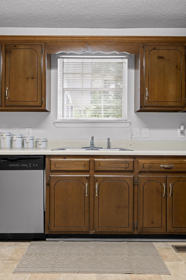 8616 Oak View Dr, Chattanooga, TN 37421 - kitchen with stainless steel dishwasher, light countertops, and a textured ceiling