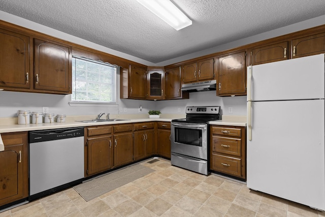 8616 Oak View Dr, Chattanooga, TN 37421 - kitchen featuring appliances with stainless steel finishes, under cabinet range hood, light countertops, and a textured ceiling
