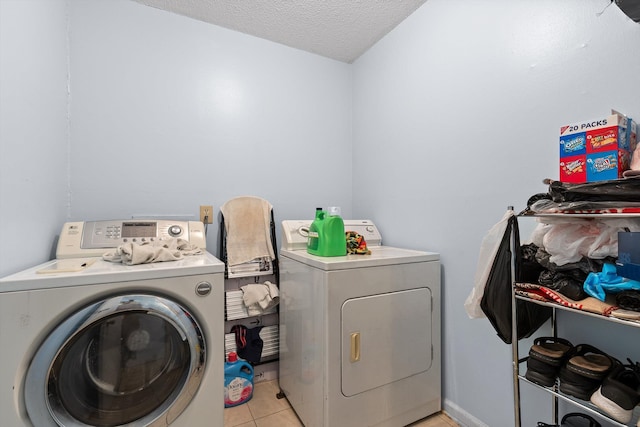 1433 Stratton Place Dr, Chattanooga, TN 37421 - washroom with washer and clothes dryer, a textured ceiling, and light tile patterned floors