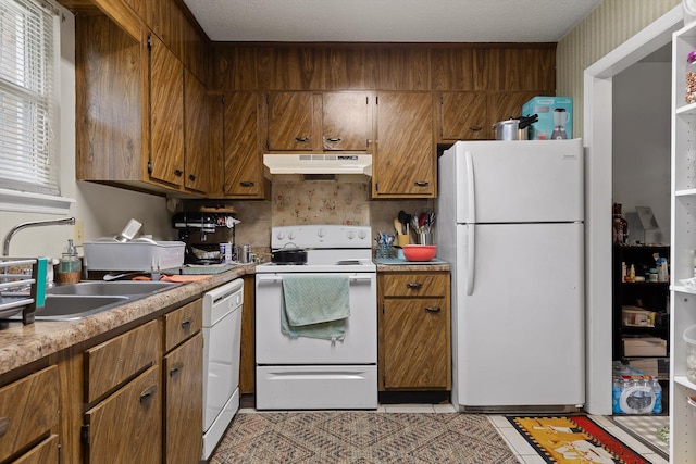 1433 Stratton Place Dr, Chattanooga, TN 37421 - kitchen featuring white appliances, under cabinet range hood, light countertops, and brown cabinets