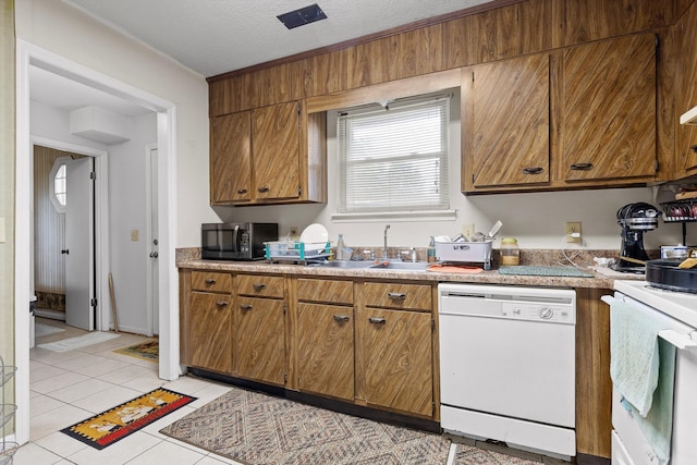 1433 Stratton Place Dr, Chattanooga, TN 37421 - kitchen featuring white appliances, brown cabinets, light tile patterned floors, light countertops, and a textured ceiling