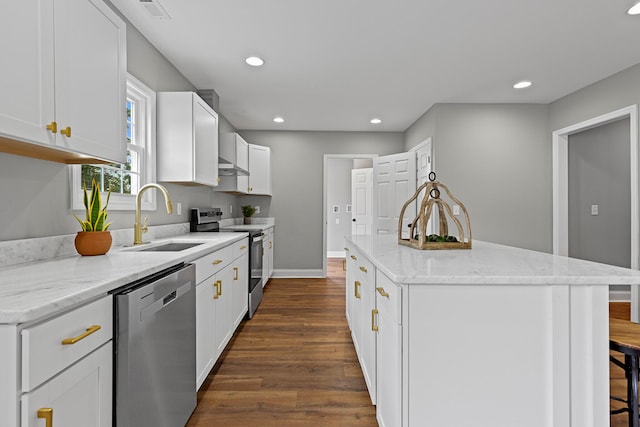 2001 Vine St, Chattanooga, TN 37404 - kitchen with stainless steel appliances, a kitchen island, dark wood finished floors, recessed lighting, and white cabinetry