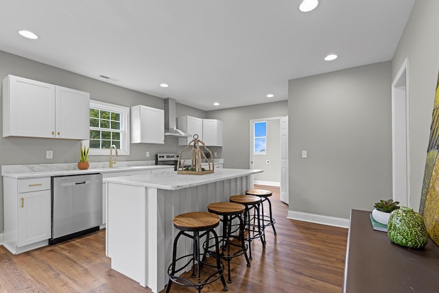 2001 Vine St, Chattanooga, TN 37404 - kitchen featuring dishwasher, wall chimney range hood, a kitchen breakfast bar, a center island, and dark wood finished floors