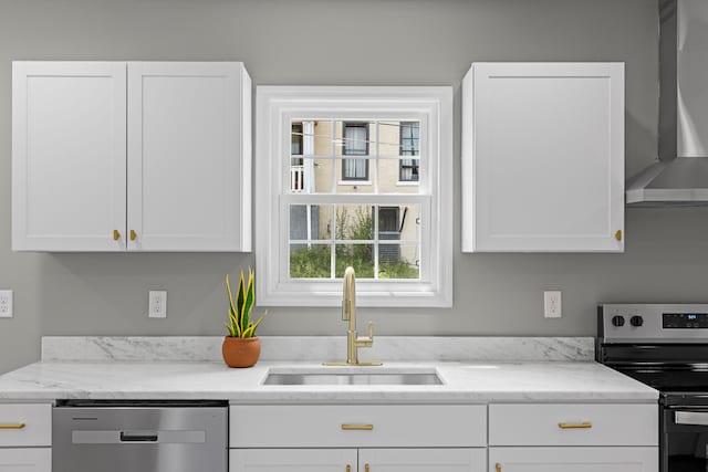 2001 Vine St, Chattanooga, TN 37404 - kitchen with stainless steel appliances, wall chimney exhaust hood, white cabinetry, and light stone countertops